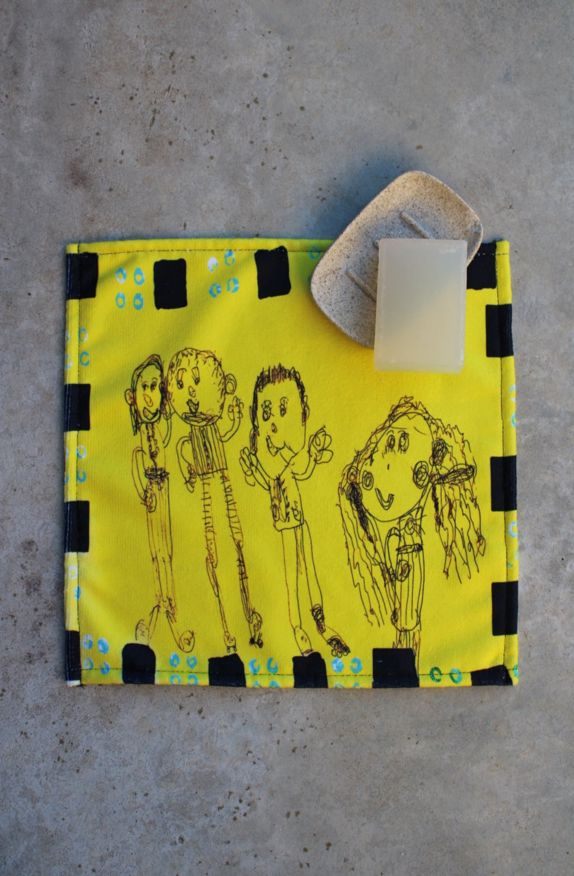 Yellow bag with black illustrations on a concrete surface